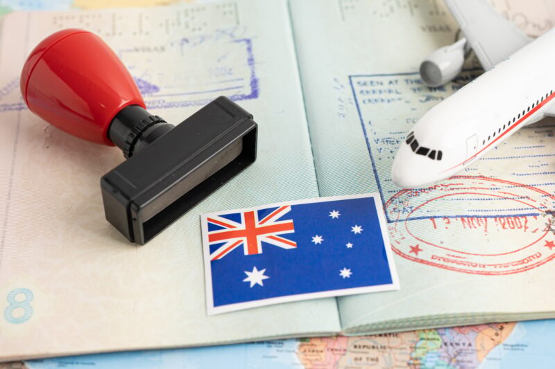 Approved Stamp visa and passport with Australia flag document to immigration at airport in country.